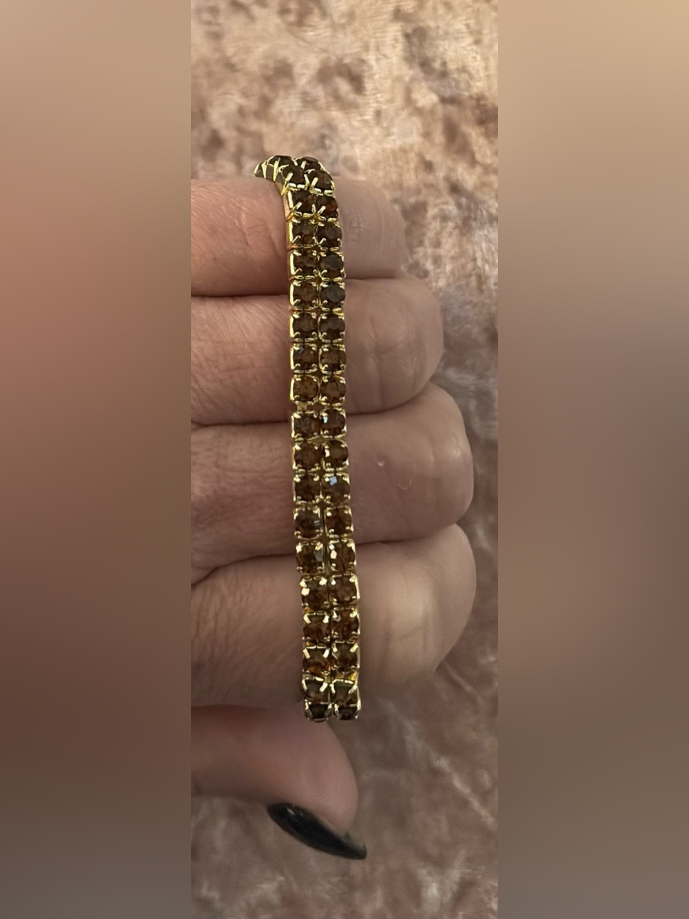 Gold-tone bracelet with small brown stones.